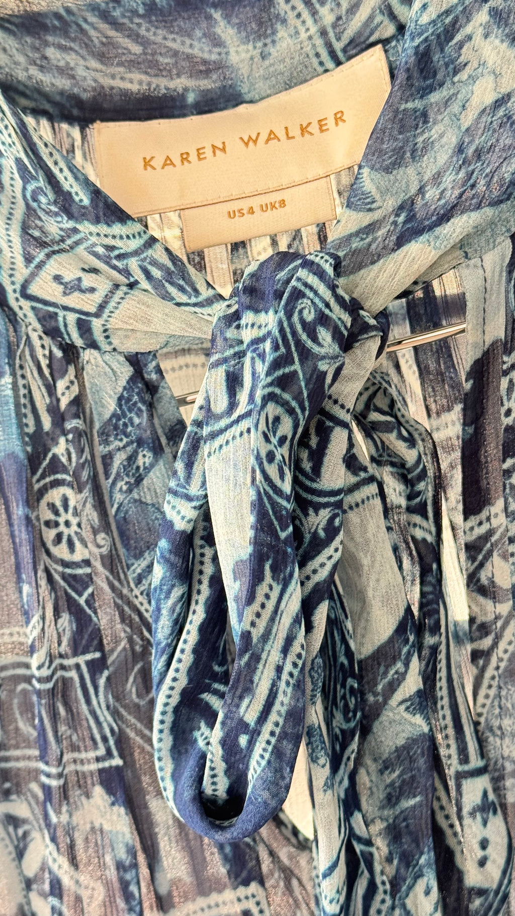 Close-up of a patterned garment with a 'Karen Walker' label.