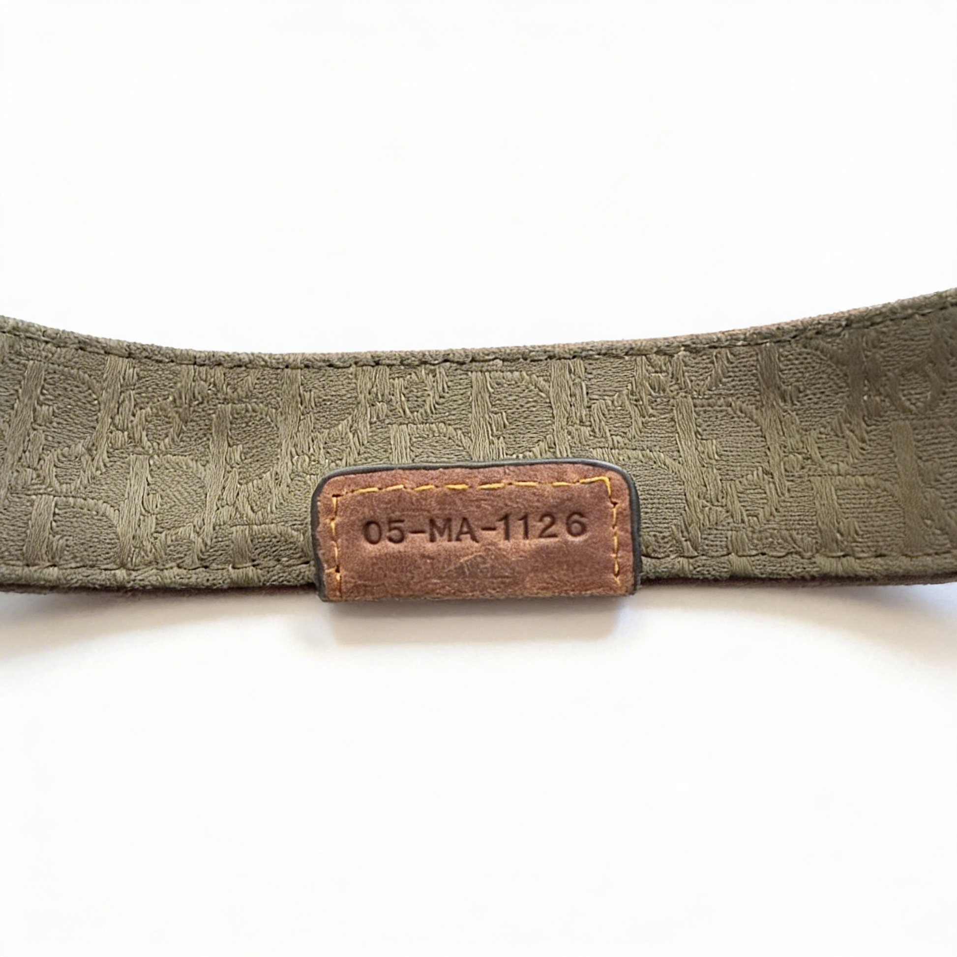 dior gaucho bag with a brown leather label on a white background